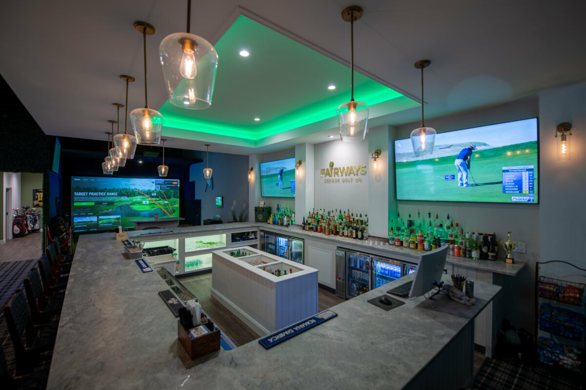 The bar and several large televisions at Fairways Indoor Golf